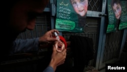 A girl receives polio vaccine drops at a government hospital in Peshawar on March 3.