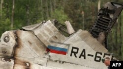 A rescuer walks amid the debris of the RusAir Tu-134 passenger jet at the crash site near Petrozavodsk.