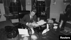 Президент США Джон Кеннеди подписывает распоряжение о перехвате судов, доставляющих на Кубу ракеты и другое вооружение. 23 октября 1962 года