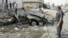 Iraqi security personnel inspect the site of a car-bomb attack in Kirkuk on August 16.