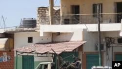 Rebel fighters are seen in a machine-gun mounted truck in Zawiya on August 14.