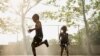 Children run through a sprinkler system installed inside a playground to cool off in the summer heat in New York City on July 17.