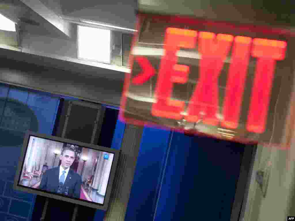 A television monitor in the White House's press briefing room displays U.S. President Barack Obama on June 22 as he announces a withdrawal of troops from Afghanistan.Photo by Saul Loeb for AFP