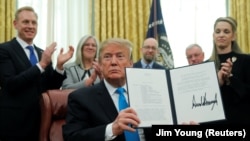 U.S. President Donald Trump displays "Space Policy Directive 4" after signing it to establish a Space Force, 