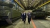 Russian President Vladimir Putin (left) listens to Andrei Terlikov, the head of the Ural Transport Machine Building Design Bureau, as they walk past military vehicles at the Uralvagonzavod factory in Nizhny Tagi, Russia. (file photo)