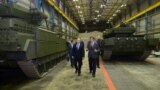 Russian President Vladimir Putin (left) listens to Andrei Terlikov, the head of the Ural Transport Machine Building Design Bureau, as they walk past military vehicles at the Uralvagonzavod factory in Nizhny Tagi, Russia. (file photo)
