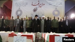 Iran Supreme Leader Ayatollah Ali Khamenei (center) and Revolutionary Guards commander Mohammad Ali Jafari (center left) pray over the coffins of Islamic Revolutionary Guards Corps officers killed in the November 12 blast near Tehran.
