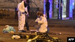 Italian police and forensics experts gather around the body of suspected Berlin truck attacker Anis Amri after he was shot dead in Milan on December 23.
