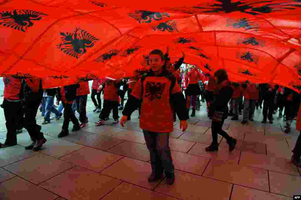 Ethnic Albanian children march under Albanian flags in Pristina, Kosovo, during celebrations of the 100th anniversary of Albania's declaration of independence on November 28. (AFP/Armend Nimani)