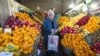 Iran -- A man leaves after shopping at a fruit store in Tehran, 06Jan2012