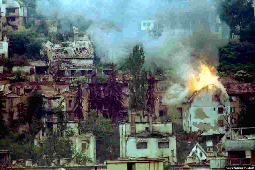 A house burning in Sarajevo after a direct hit from a mortar in 1994. A UN commission concluded in 1994, with the siege still continuing, that property damage &quot;includes specifically protected targets such as hospitals and medical complexes, medical facilities...medical personnel, as well as cultural property&quot; and tens of thousands of apartments.