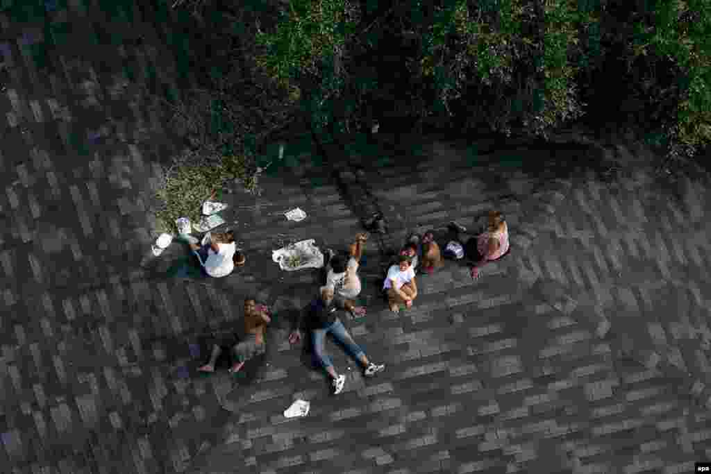 Residents trapped by floods sit on a rooftop in Baton Rouge, Louisiana, on August 30.