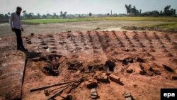 A man surveys the brick kiln where a Christian couple was cremated after being beaten to death in Pakistan for alleged blasphemy.