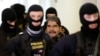 Salih Muslim is escorted to a Czech court in Prague on February 27.