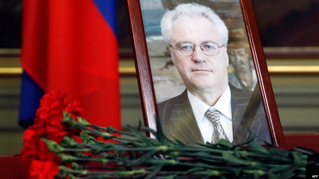 Flowers are laid in front of a portrait of Russian Ambassador to the United Nations Vitaly Churkin at the Foreign Ministry guest house in Moscow on February 21. Churkin died suddenly the previous day.