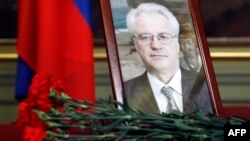 Flowers are laid in front of a portrait of Russian Ambassador to the United Nations Vitaly Churkin at the Foreign Ministry guest house in Moscow on February 21. Churkin died suddenly the previous day. 