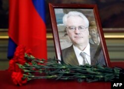 Flowers are laid in front of a portrait of Russian Ambassador to the United Nations Vitaly Churkin at the Foreign Ministry guest house in Moscow on February 21. Churkin died suddenly the previous day.