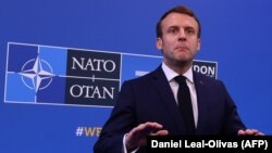 U.K. -- French President Emmanuel Macron speaks to the press on arrival at the NATO summit at the Grove hotel in Watford, northeast of London, December 4, 2019