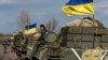 A convoy of Ukrainian armed forces, including armored personnel carriers, military vehicles, and cannons, prepares to move as the troops pull back from the Debaltseve region, in Blahodatne, on February 27.