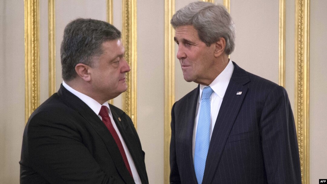Ukrainian President Petro Poreshenko (left) greets U.S. Secretary of State John Kerry prior to their meeting in Kyiv on February 5.