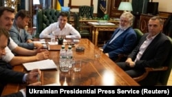 President Volodymyr Zelenskiy (in white) meets with Ihor Kolomoyskiy (in blue jacket) in Kyiv on September 10.