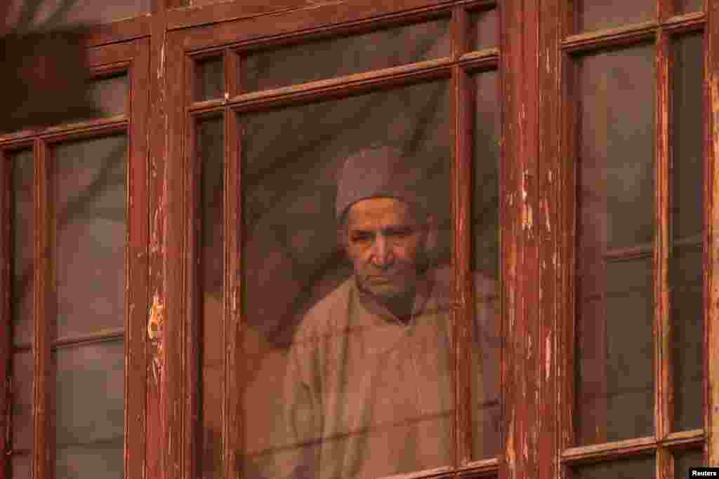 A man looks from a window of a house in Srinagar during a strike called by Kashmiri separatists against the recent killings in Kashmir. (Reuters/Danish Ismail)