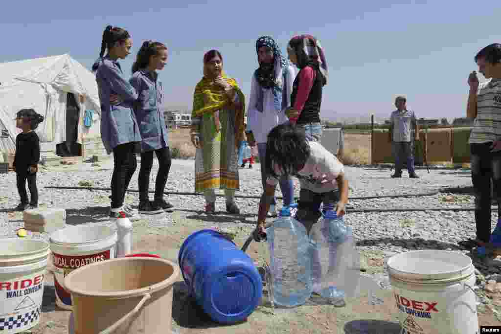 Yousafzai talks with schoolgirls at the Abrar Syrian refugee informal settlement in Lebanon&#39;s Bekaa Valley on July 12, 2015.