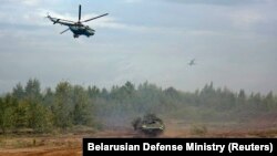 Helicopters and an armored vehicle are seen during the Zapad 2017 war games at an undisclosed location on September 14.