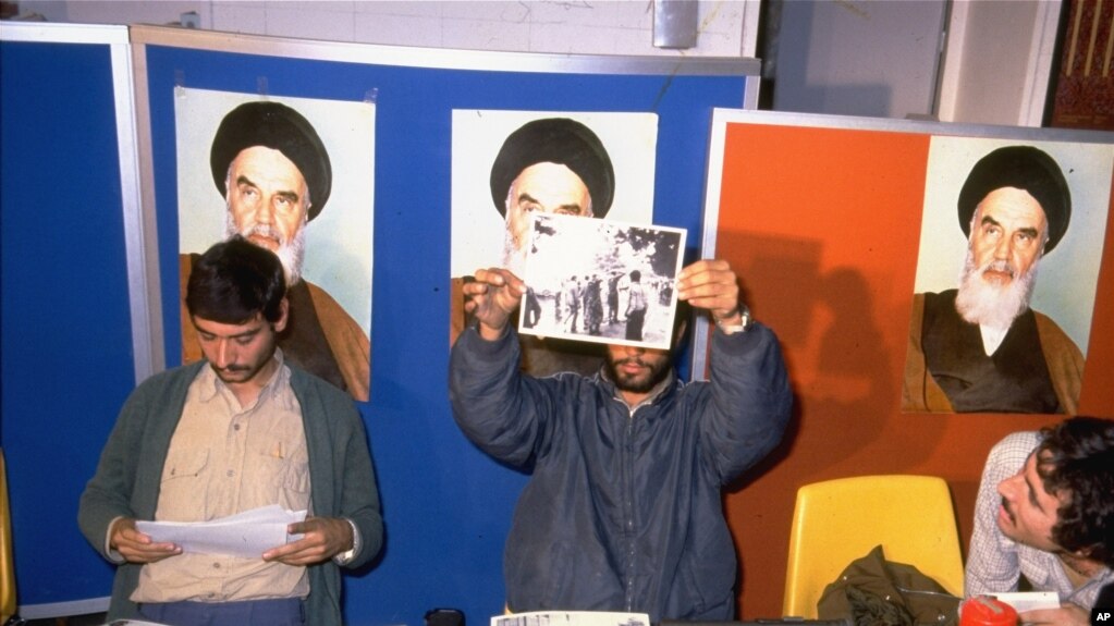 Iranian student spokesmen hold up photos of blindfolded American hostages, during a press conference in Tehran Monday November 5, 1979. The hostages are members of the staff of the United States Embassy in Tehran, which was stormed by students November 4