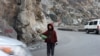 Eight-year-old Hedayat guides traffic through the Mahipar Gorge along the Kabul-Jalalabad Highway in Afghanistan. Hedayat, the eldest son of his six-member family, guides traffic with his bottle from dawn to dusk on the highway, making roughly $3 a day. Poverty and insecurity have forced thousands of children into child labor in Afghanistan. Instead of attending school, many children aged 5 to 15 work on the streets and are often the sole breadwinners for their families. (AFP/Noorullah Shirzada)