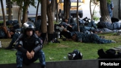 Armenia - Police officers sleep on the ground on a blocked street in Yerevan leading to a police station seized by anti-government gunmen, 19Jul2016.