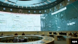 Russian defense officials sit in front of a map of air-defense locations in the area of Donetsk during a briefing by Russian Lieutenant General Andrei Kartopolov and Lieutenant General Igor Makushev in Moscow on July 21 to present Moscow's view of the MH17 downing.