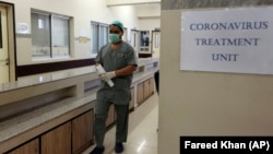 A doctor enters an isolation ward set up at the Jinnah Postgraduate Medical Center in Karachi, Pakistan.