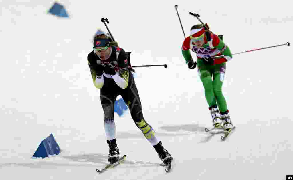Slovakia's Anastasiya Kuzmina (left) and Olga Vilukhina of Russia compete during the women's 10 kilometer pursuit competition at the Laura Cross Country Center.