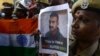 Indian security forces pose with the national flag and pictures of Indian Air Force pilot Abhinandan Varthaman during an event to pray for his return, at Kalikambal temple in Chennai on March 1.