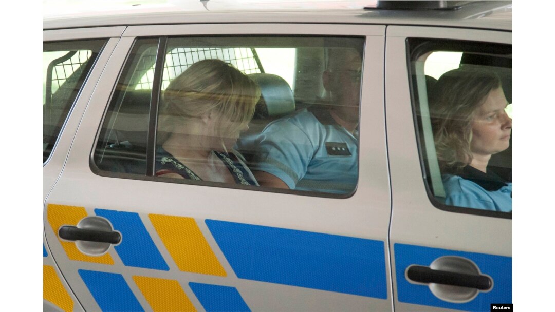Jana Nagyova sits in a police car after being arrested for abuse of power and bribery.