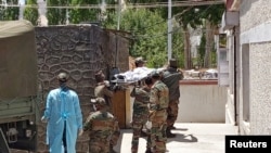 Indian army soldiers carry the body of their colleague, who was killed in a border clash with Chinese troops, to an autopsy centre at the Sonam Norboo Memorial Hospital in Leh, the capital of Ladakh on June 17.