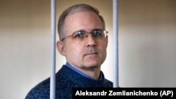 Paul Whelan stands in a cage while waiting for a hearing in a courtroom in Moscow on August 23.