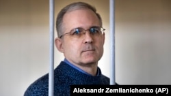 Paul Whelan stands in a cage while waiting for a hearing in a courtroom in Moscow on August 23.