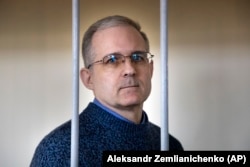Paul Whelan, a former U.S. Marine, stands in a cage while waiting for a hearing in a courtroom in Moscow in August 2019.