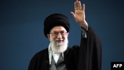 Iranian Supreme Leader Ayatollah Ali Khamenei waves to the crowd during a meeting in Tehran on February 17.