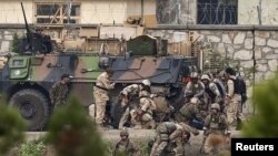 NATO and Afghan troops attend to casualties during the battle with Taliban insurgents who took over a building near the US Embassy in Kabul on September 13-14.