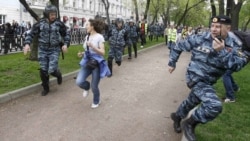 Russian riot police chase opposition supporters during an unsanctioned protest in Moscow on May 7.