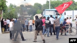 Protesters wave a flag in the street in Jalal-Abad on May 14 during the unrest.