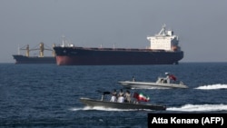 Iranian naval forces take part in the "National Persian Gulf day" in the Strait of Hormuz, April 30, 2019, with oil tankers in the background.