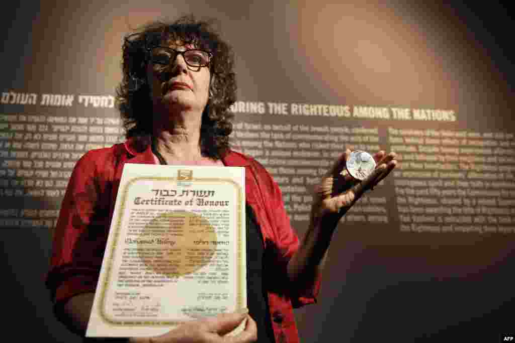 Irena Steinfeldt, the director of the Righteous Among the Nations department at the Yad Vashem Holocaust memorial Museum, holds the "Righteous Among The Nations" in Jerusalem. (AFP/Gali Tibbon)