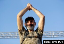 Opposition lawmaker Nikol Pashinian gestures as he addresses his supporters in Republic Square in Yerevan on May 2.