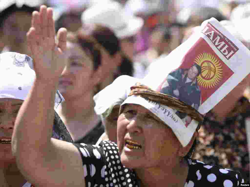 A woman with a portrait of city Mayor Melis Myrzakmatov takes part in a rally in central Osh on August 20. The powerful mayor of Kyrgyzstan's second city addressed 1,500 supporters to deny rumors he had been fired from his post in Osh, epicenter of savage ethnic clashes that killed hundreds of people in June. Photo by Vladimir Pirogov for Reuters