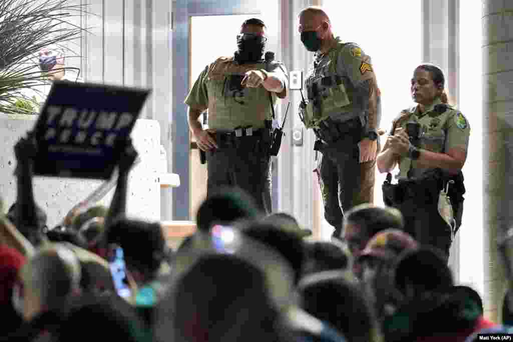 Maricopa County Sheriff's Deputies stand at the door of the Maricopa County Recorder's Office as President Donald Trump supporters rally outside, November 4, 2020, in Phoenix. Arizona.