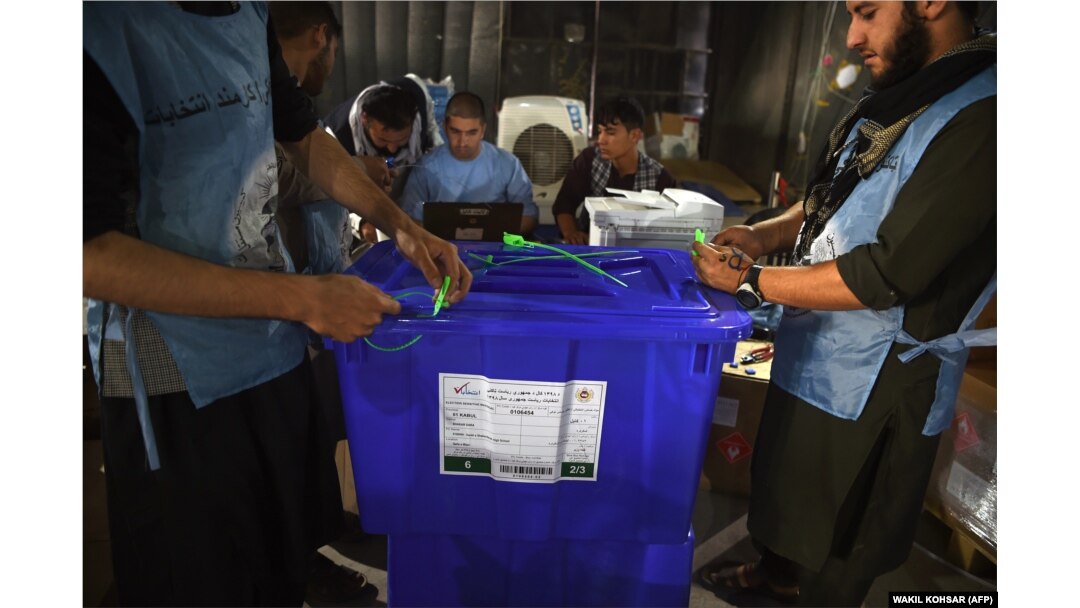 Independent Election Commission workers seal ballot boxes as they prepare for the upcoming presidential election at a warehouse in Kabul on September 16.